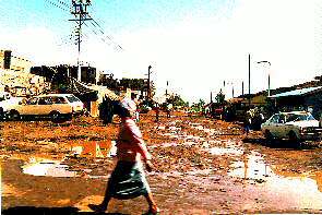Eine Straße in den Slums nach dem Regen. A Street in the slums after the rain.